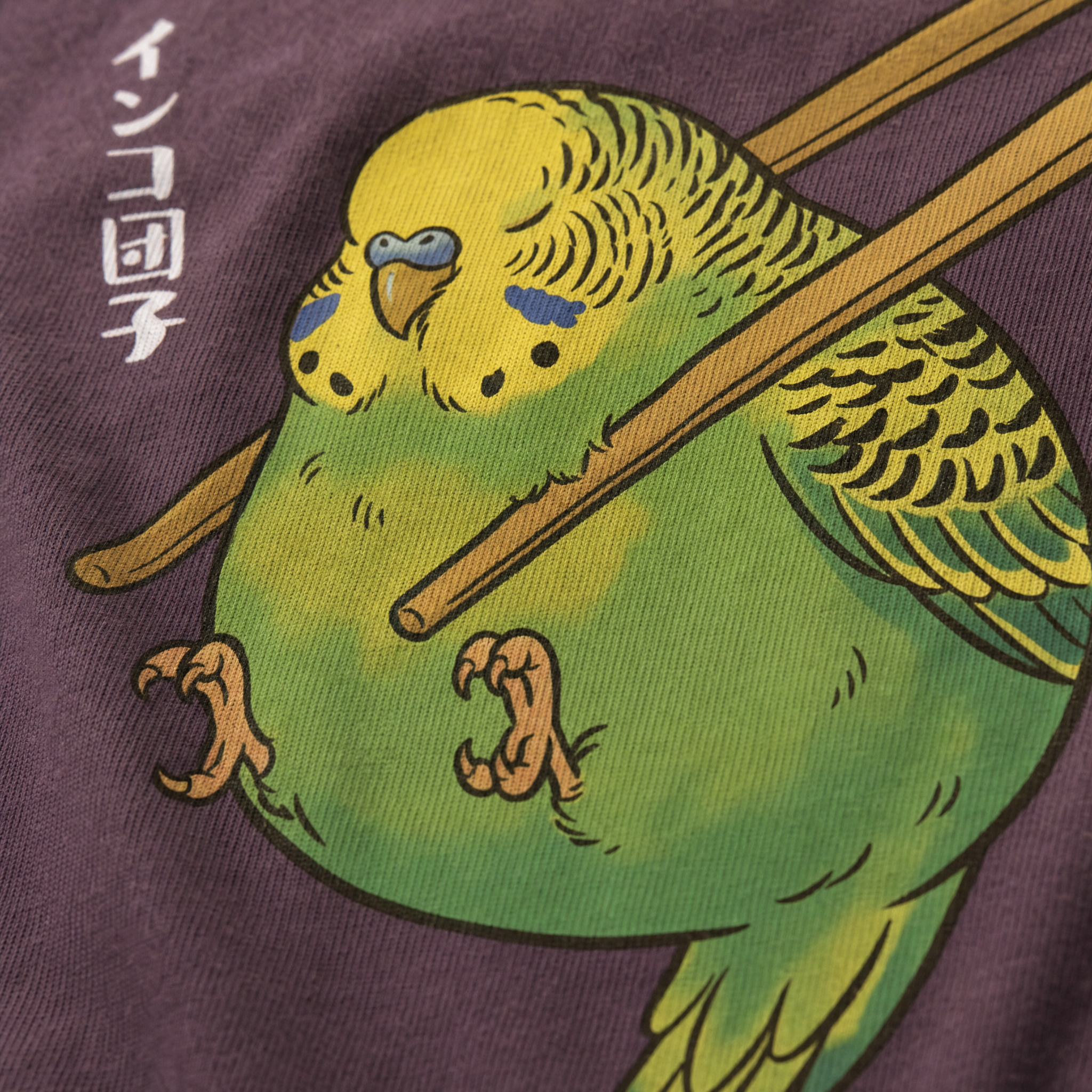 Maroon t-shirt printed with a cartoon budgie holding a pair of chopsticks