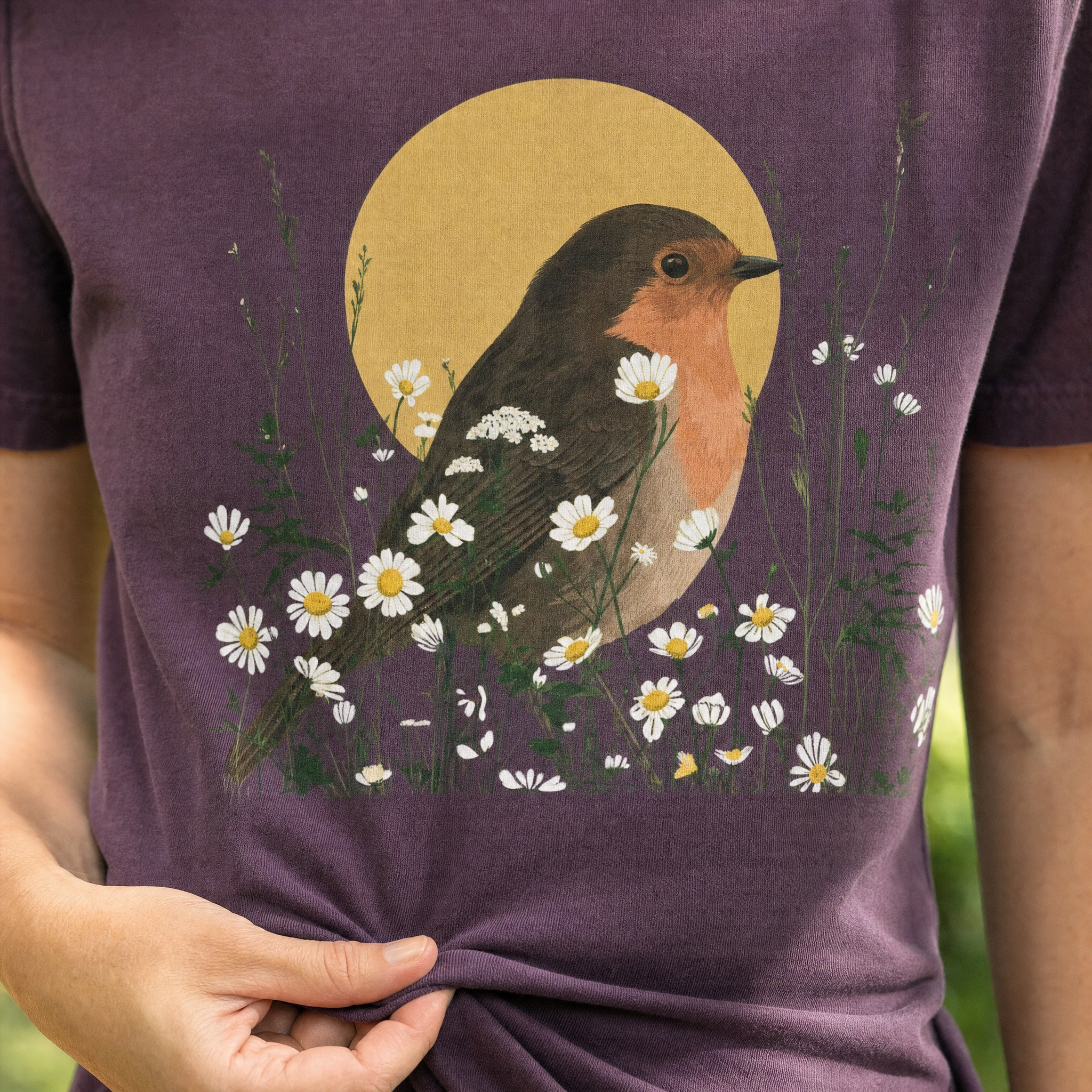 Plum t-shirt printed with a robin among daisies before a golden moon